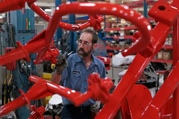 Kuhn Employee working on a speedrake wheel rake