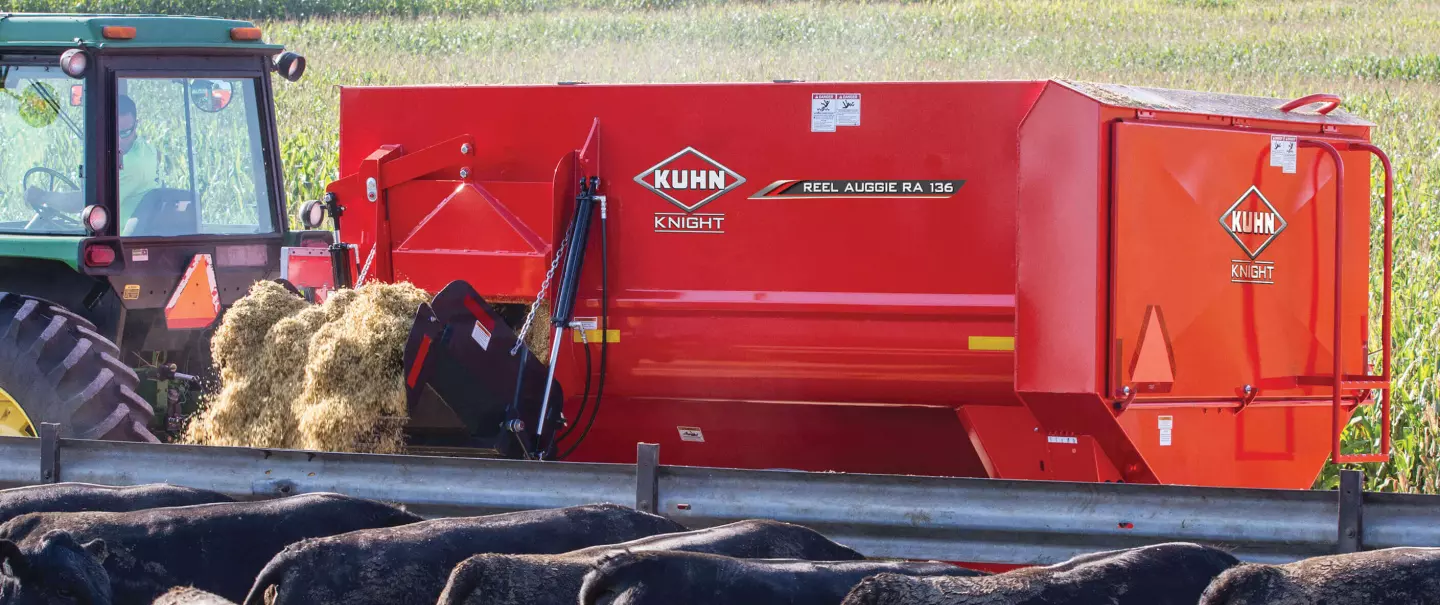 In the foreground you can see a RA 136 mixer delivering feed to a feedlot of cattle.